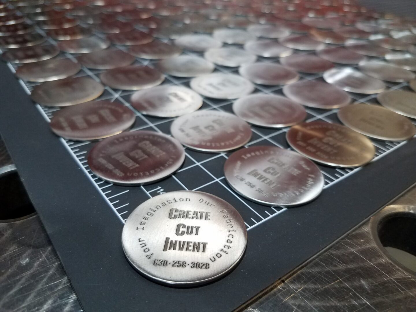 A table with many coins and some metal discs