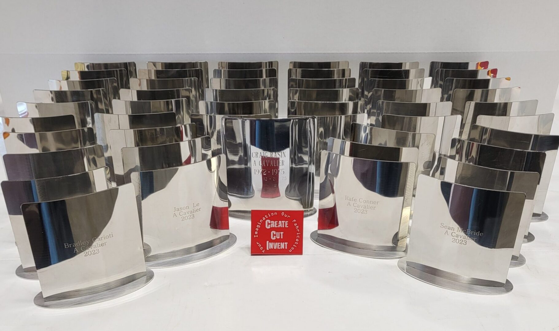 A group of silver trophies sitting on top of a table.