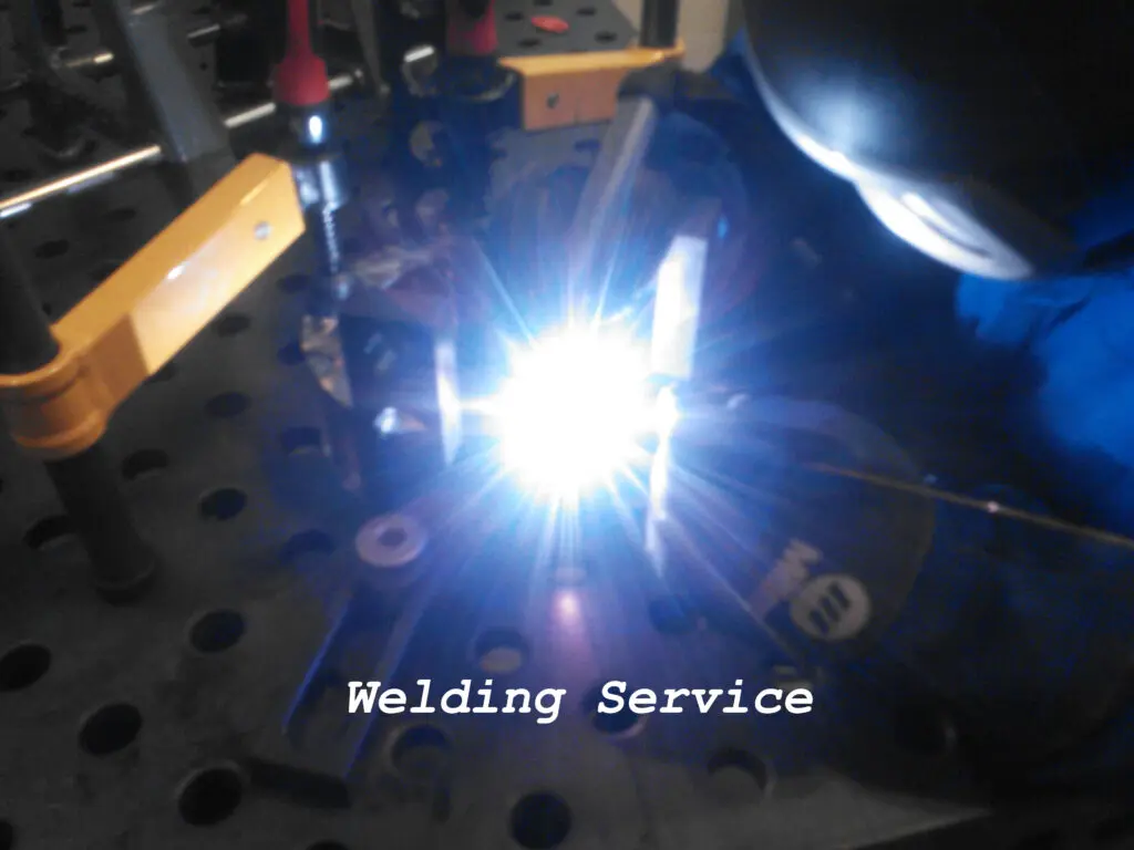 A person welding something in the dark.